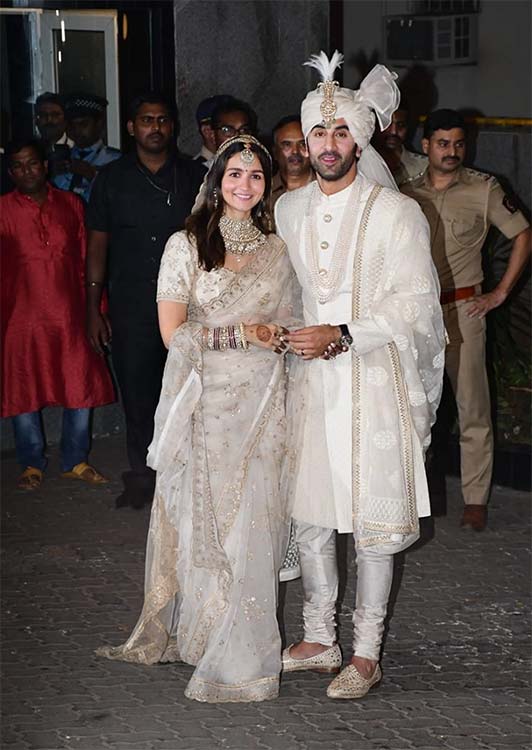 Alia Bhatt and Ranbir Kapoor in ivory wedding outfits after their wedding ceremony
