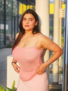 Cute Indian bhabhi in pink outfit posing gracefully in natural light