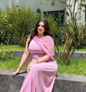 Beautiful Indian bhabhi in pink saree sitting outdoors – stylish and graceful look