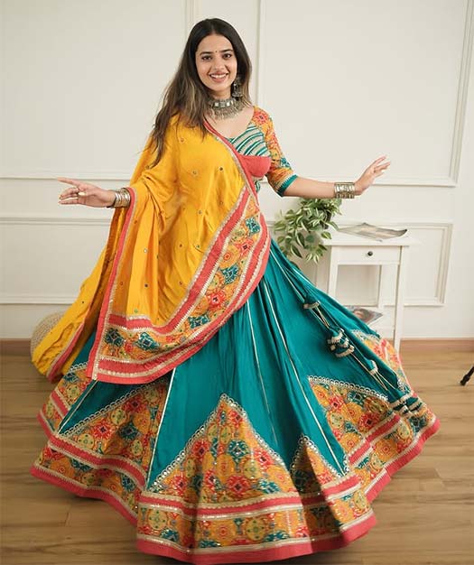 Gujarati girl in traditional teal and yellow lehenga for Garba