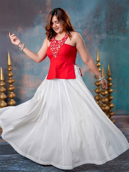 Girl in Indo-Western Navratri outfit wearing red halter-neck top with white skirt