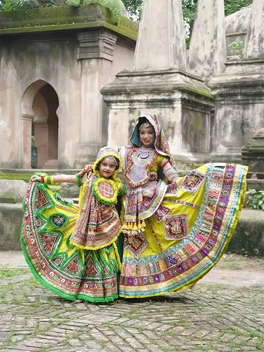 Baby girl in traditional yellow and green chaniya choli for Navratri Garba