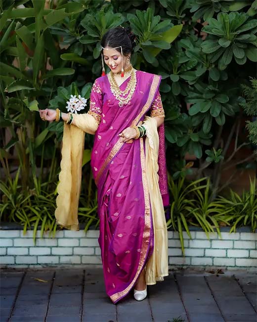 Woman in purple Nauvari saree with beige dupatta and Maharashtrian jewellery