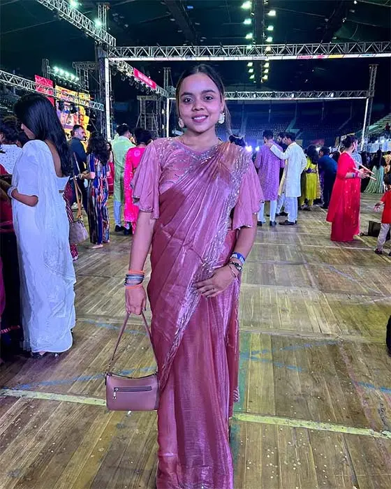 Girl in rose-pink saree styled for Garba Navratri celebration.