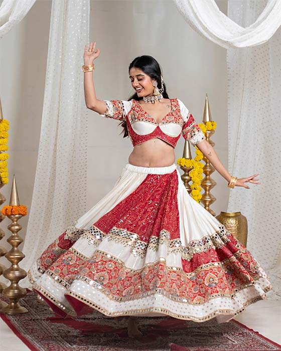 Navratri look for women in red and white lehenga with mirror work
